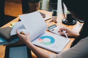 Business woman looking at charts, spreadsheets, graph financial development, bank accounts